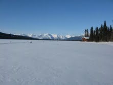Our Peace of Selby Wilderness Lodge - adjacent to the spruce bough marked skiway- with the Brooks Range mountains in the background