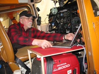 Art installing a laptop computer inside the cockpit of the Polar Pumpkin.