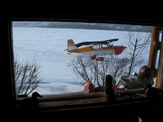 The Citabria aircraft on skis parked just outside our lodge window at Selby Lake