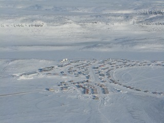 Flying the Polar Pumpkin over the village of Ulukhaktok on the way to the North Pole
