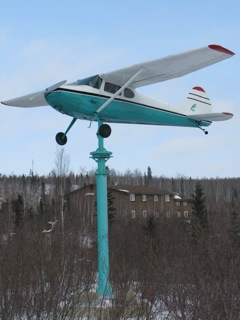 Cessma 170 on a pedestal - acting as a weather vane -�visible as one enters the city of Inuvik.�Freddie Carmichael, an early bush pilot in this area flew the airplane in the 1950s; and started Reindeer Air Service.�